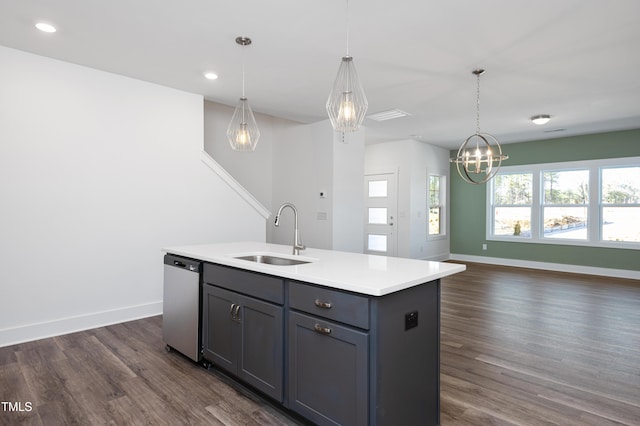 kitchen featuring sink, hanging light fixtures, an island with sink, and dishwasher