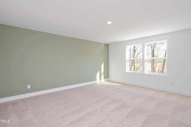 unfurnished room with light colored carpet