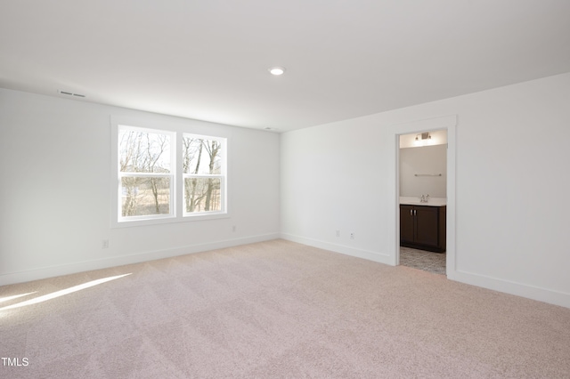 carpeted spare room with sink