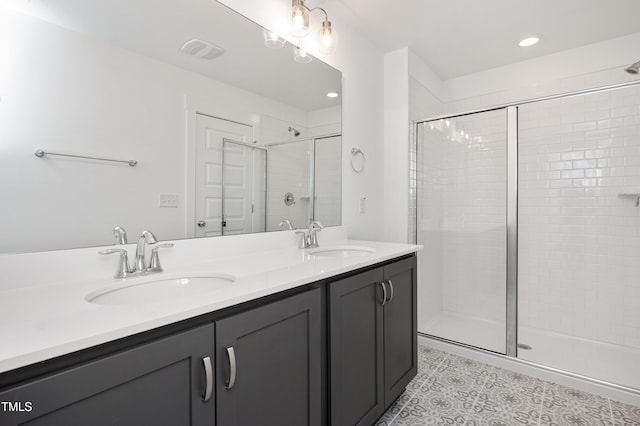 bathroom featuring tile patterned floors, vanity, and a shower with shower door