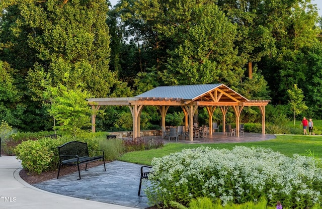 view of home's community with a yard and a patio