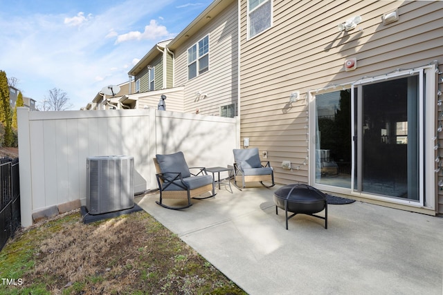 view of patio featuring central air condition unit and an outdoor fire pit