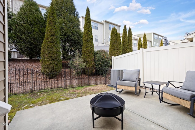 view of patio with central AC and a fire pit