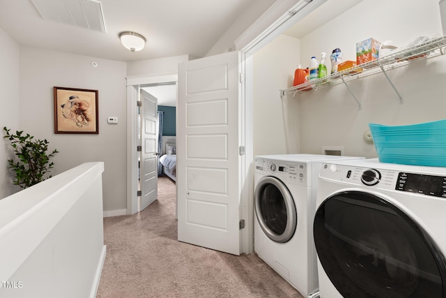 washroom with light colored carpet and washing machine and clothes dryer