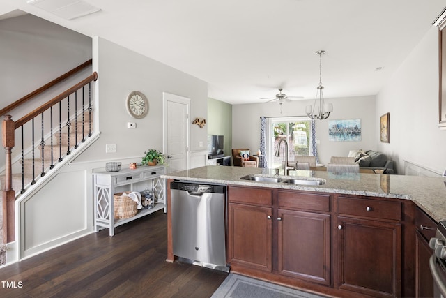 kitchen featuring sink, light stone counters, hanging light fixtures, stainless steel dishwasher, and dark hardwood / wood-style flooring