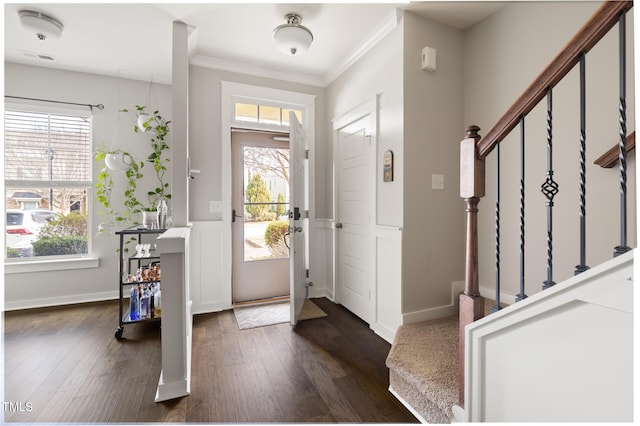 entrance foyer with dark hardwood / wood-style flooring, plenty of natural light, and ornamental molding