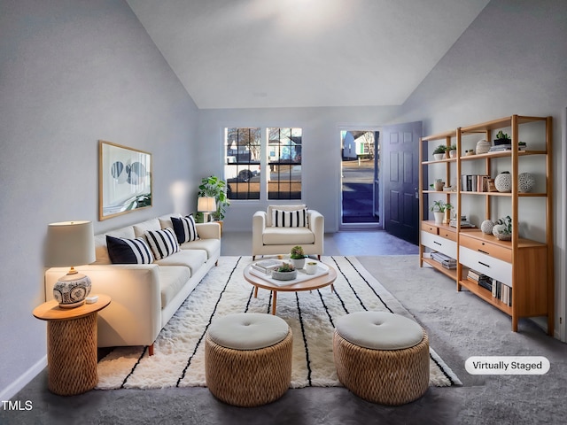 interior space featuring high vaulted ceiling and concrete flooring