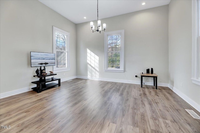 dining room with baseboards, a wealth of natural light, visible vents, and light wood-style floors