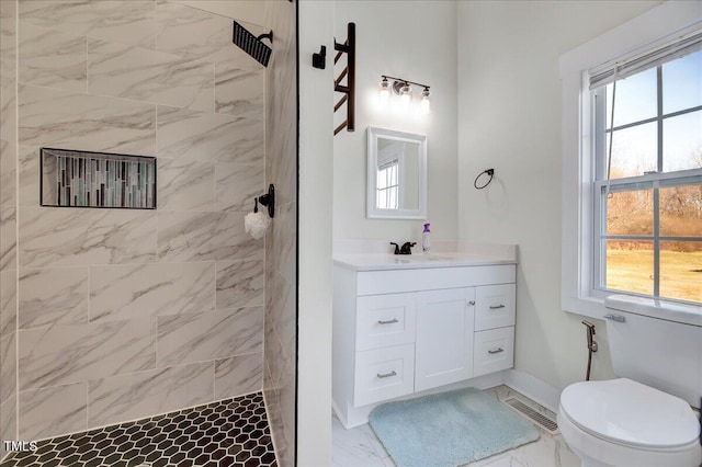 bathroom with marble finish floor, visible vents, a walk in shower, and vanity