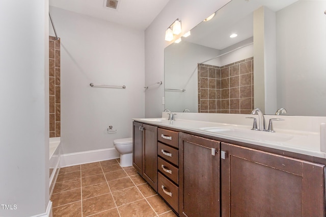 bathroom featuring baseboards, a sink, toilet, and tile patterned floors