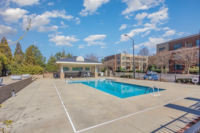 pool with a gazebo, a patio area, and fence