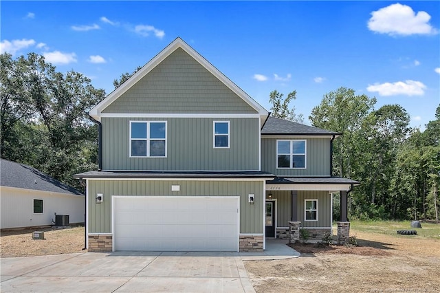 4728 Butler Nursery Rd, Fayetteville, NC 28306 - craftsman house featuring driveway, stone siding, cooling unit, an attached garage, and a porch