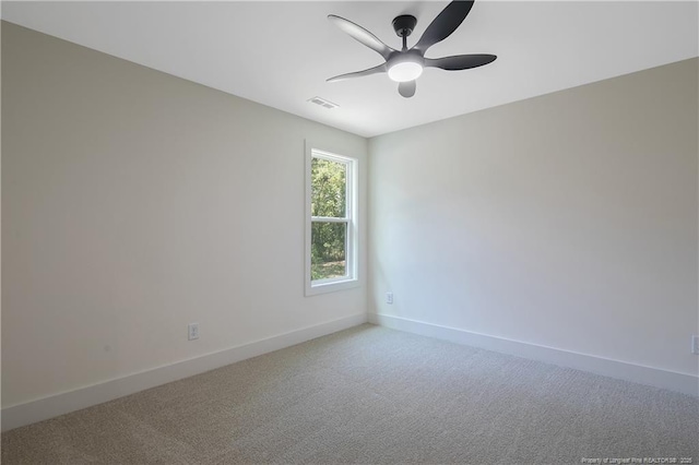 carpeted spare room with ceiling fan