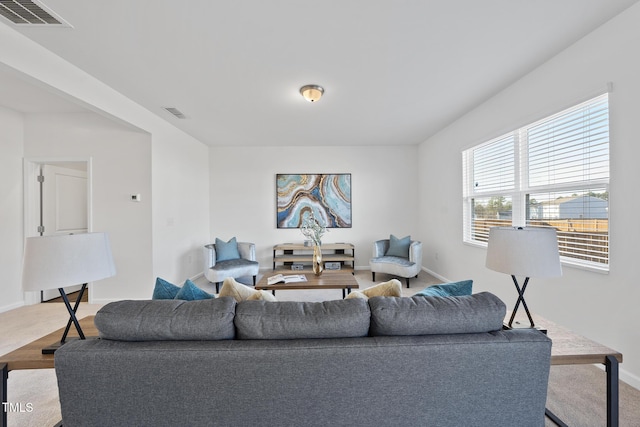 living room featuring baseboards and visible vents