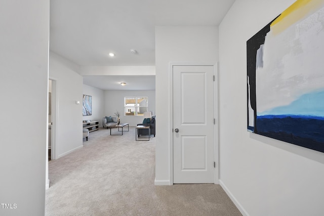 corridor featuring carpet and baseboards