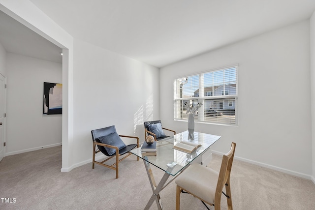 carpeted home office featuring baseboards