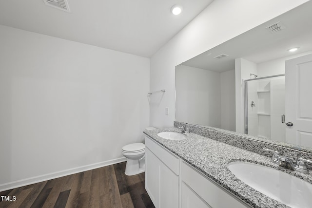 full bathroom featuring visible vents, a sink, and wood finished floors