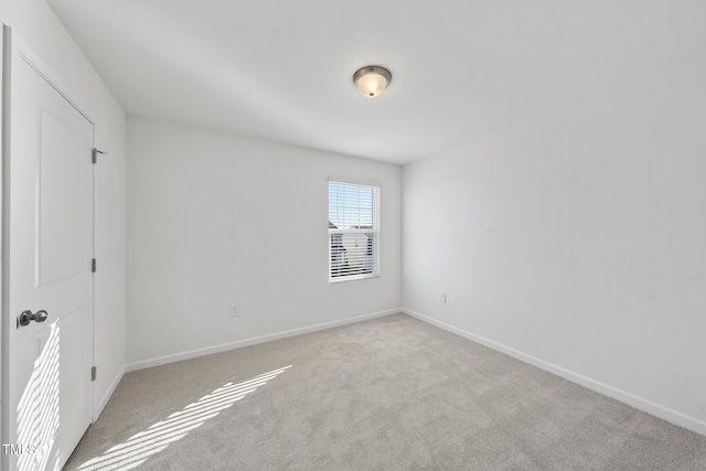 unfurnished bedroom with light carpet and baseboards