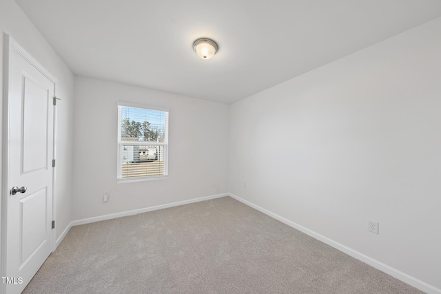 empty room with carpet floors and baseboards