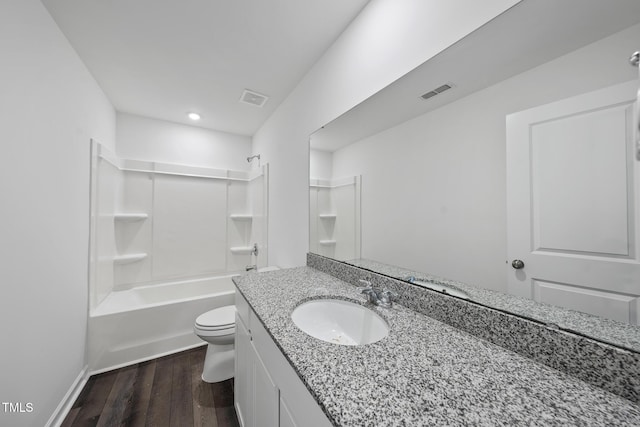 full bath with visible vents, bathing tub / shower combination, toilet, wood finished floors, and vanity