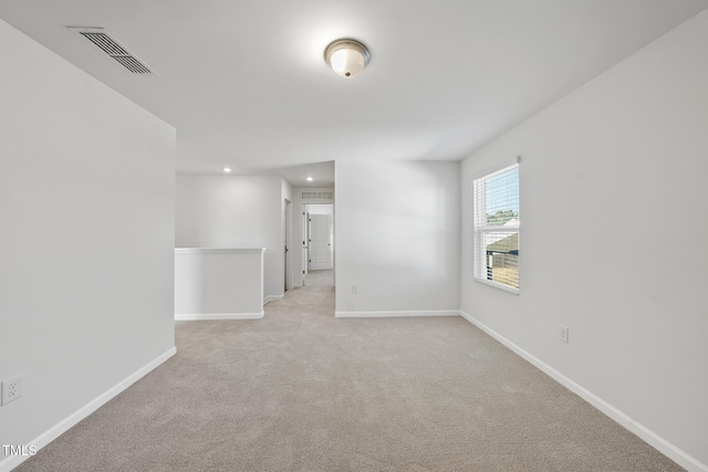 unfurnished room featuring recessed lighting, baseboards, visible vents, and light colored carpet