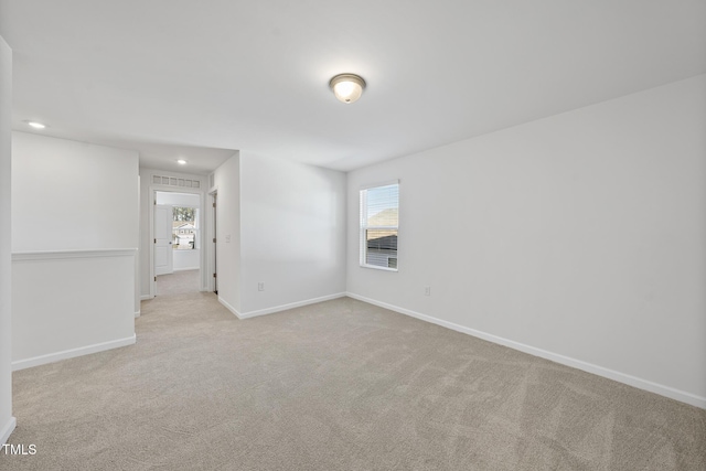 empty room with recessed lighting, baseboards, and light colored carpet