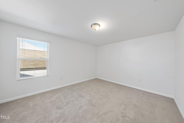 empty room with carpet and baseboards