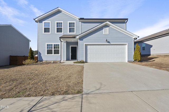 traditional home with concrete driveway, fence, and an attached garage