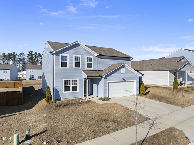 traditional home with a garage, driveway, and fence