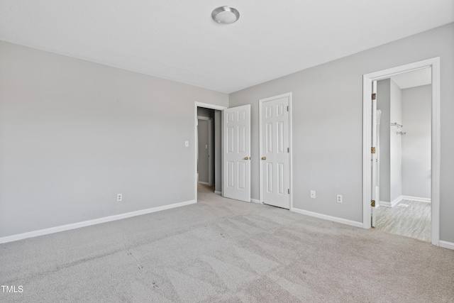 unfurnished bedroom featuring carpet flooring and baseboards