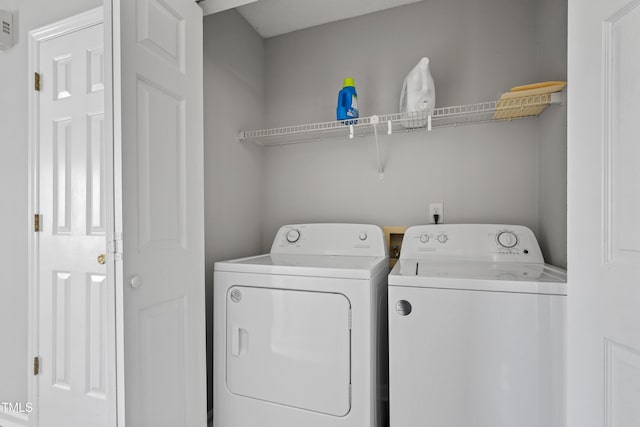 clothes washing area featuring laundry area and washing machine and dryer