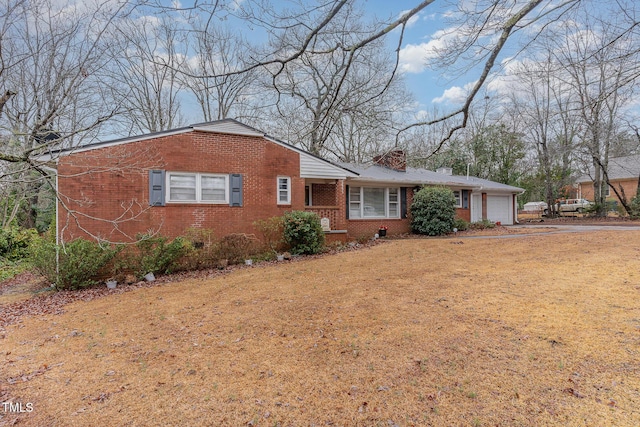 view of front of home with a garage and a front yard