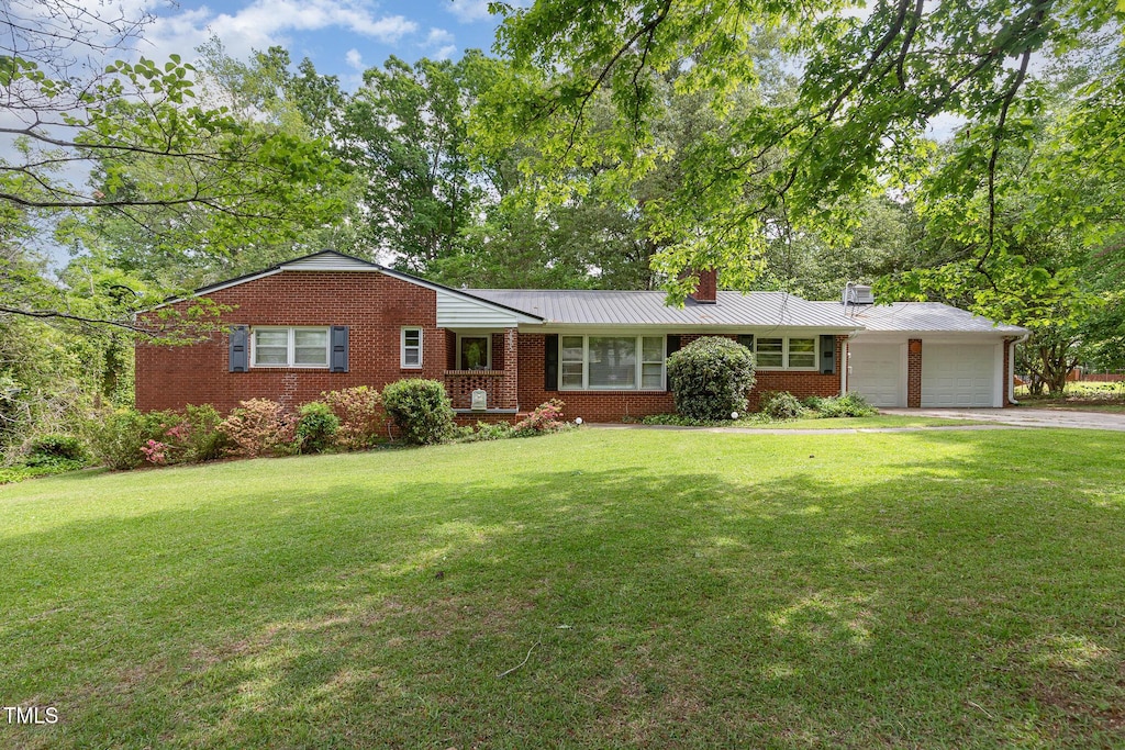 2005 Sutphin Dr, Sanford, NC 27330 - ranch-style home with a front yard, a chimney, brick siding, and an attached garage