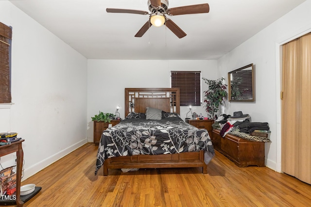 bedroom featuring a ceiling fan, wood finished floors, and baseboards