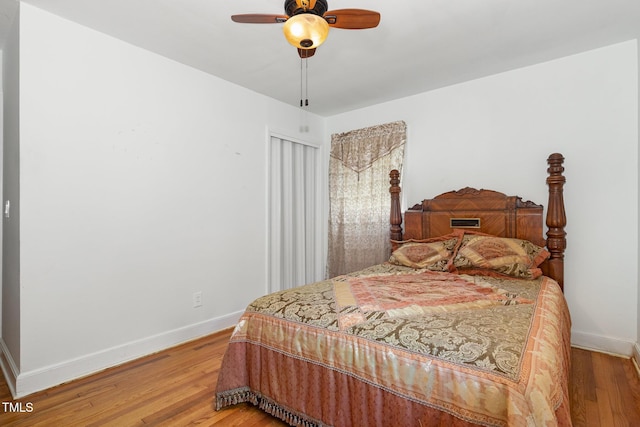 bedroom featuring ceiling fan, light wood finished floors, and baseboards