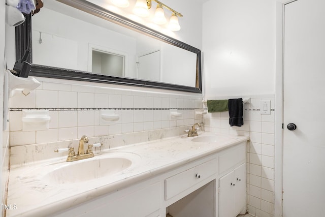 full bathroom with double vanity and a sink