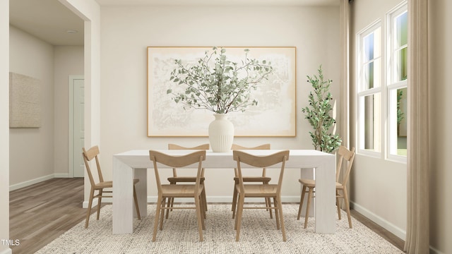 dining area featuring hardwood / wood-style flooring and a healthy amount of sunlight