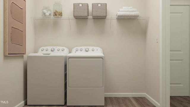 laundry room featuring hardwood / wood-style flooring and washing machine and clothes dryer