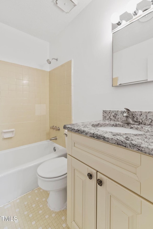 bathroom featuring shower / bathing tub combination, vanity, toilet, and tile patterned floors