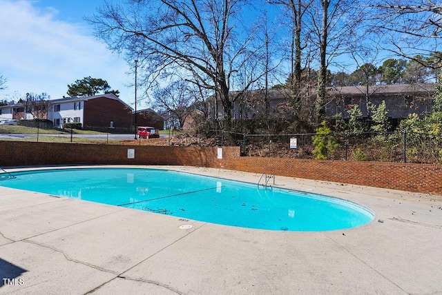 pool featuring a patio and fence