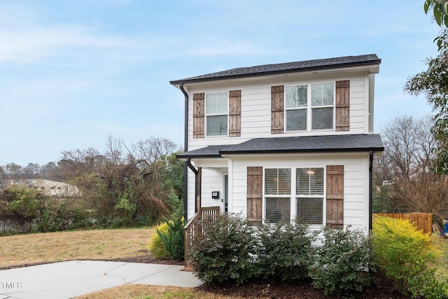 view of property featuring a front lawn