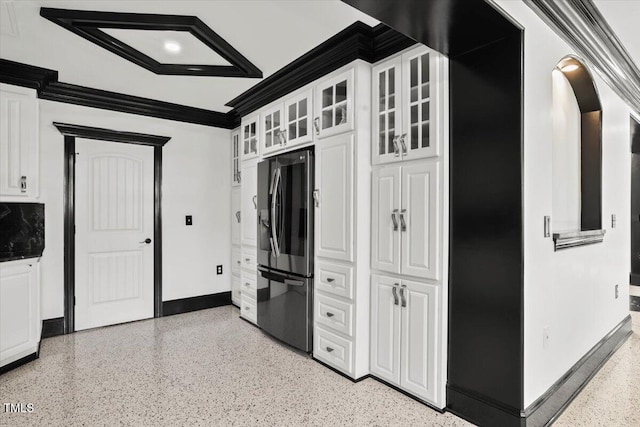 kitchen with white cabinetry, crown molding, and stainless steel refrigerator with ice dispenser