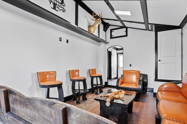 sitting room with high vaulted ceiling