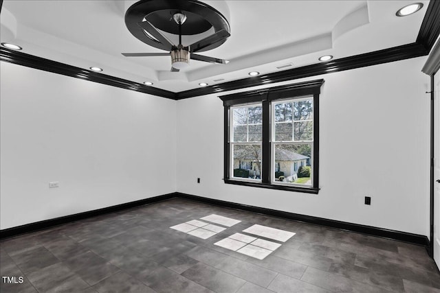 spare room featuring crown molding, a raised ceiling, and ceiling fan