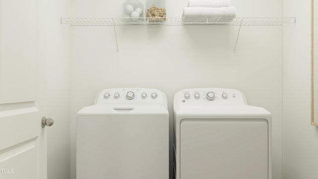 washroom with washing machine and clothes dryer