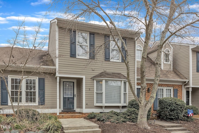 view of front of house with entry steps and brick siding