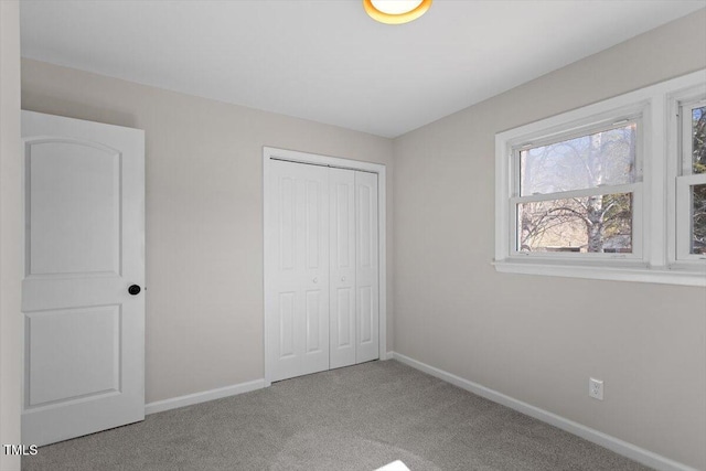 unfurnished bedroom with carpet floors and a closet