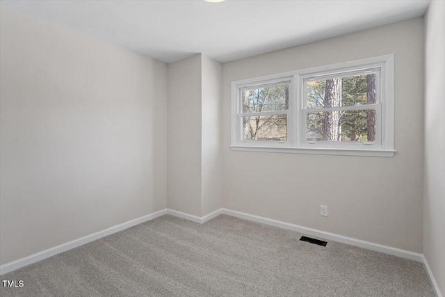 unfurnished room featuring light carpet