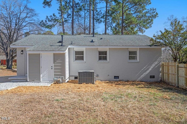 back of house with a yard and central AC