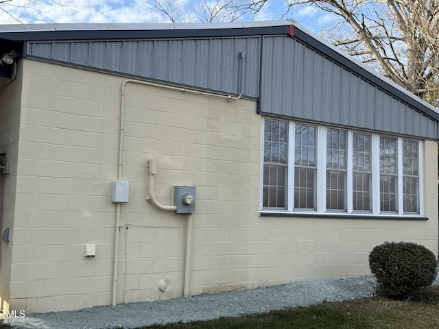 view of home's exterior with concrete block siding